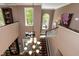A view from above shows the chandelier hanging above the foyer's wooden floors and white staircase at 126 Solterra Way, Durham, NC 27705