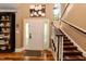 Inviting foyer featuring hardwood floors, staircase, and a bright entrance, creating a welcoming ambiance at 126 Solterra Way, Durham, NC 27705