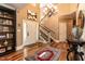 Inviting foyer with hardwood floors, white staircase, and a decorative chandelier at 126 Solterra Way, Durham, NC 27705