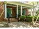 Inviting brick home featuring a charming covered front porch with blue door and matching shutters at 126 Solterra Way, Durham, NC 27705