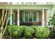 Inviting front porch with rocking chairs and manicured hedges, perfect for relaxing outdoors at 126 Solterra Way, Durham, NC 27705