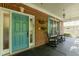 Covered front porch with rocking chairs and blue door at 126 Solterra Way, Durham, NC 27705