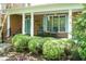 Inviting front porch with rocking chairs and manicured hedges, perfect for relaxing outdoors at 126 Solterra Way, Durham, NC 27705