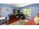 Comfortable home office with a wooden desk, and natural light from the window at 126 Solterra Way, Durham, NC 27705