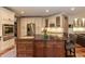 Spacious kitchen with granite counters, stainless appliances, and a central island at 126 Solterra Way, Durham, NC 27705