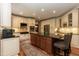 Modern kitchen with a large island, counter seating, and stainless steel appliances at 126 Solterra Way, Durham, NC 27705