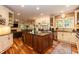 Spacious kitchen with island, granite counters, and stainless steel appliances at 126 Solterra Way, Durham, NC 27705