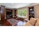 Comfortable living room features built-in shelves, a large window and decorative area rug at 126 Solterra Way, Durham, NC 27705