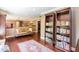 Inviting living room with bookshelves, a cozy sofa, and a decorative rug on hardwood floors at 126 Solterra Way, Durham, NC 27705