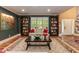 Well-lit living room features built-in shelving, large windows, and cozy furniture at 126 Solterra Way, Durham, NC 27705