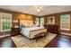 Well-lit main bedroom showcasing a tray ceiling, large rug, and stylish decor at 126 Solterra Way, Durham, NC 27705