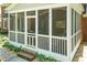 Cozy screened porch with brick foundation and white trim, perfect for outdoor living at 126 Solterra Way, Durham, NC 27705