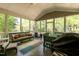 Large screened-in porch with comfortable seating and a dining table, perfect for entertaining at 126 Solterra Way, Durham, NC 27705