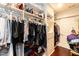 Large walk-in closet with rods and shelves provides ample storage space for clothing and personal items at 126 Solterra Way, Durham, NC 27705
