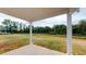 Covered patio featuring a view of the grass backyard with pond at 150 Hanover Ct, Clayton, NC 27527