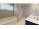 Primary bathroom with double sink vanity, soaking tub, and glass-enclosed shower stall at 150 Hanover Ct, Clayton, NC 27527