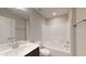 Bathroom featuring a tub shower combo with tile surround and a vanity with a white countertop at 150 Hanover Ct, Clayton, NC 27527