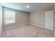 Neutral bedroom featuring carpet flooring, neutral walls, a window and a door at 150 Hanover Ct, Clayton, NC 27527