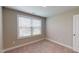 Simple bedroom with a large window providing natural light, neutral walls, and carpet flooring at 150 Hanover Ct, Clayton, NC 27527