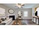 Inviting living room with a fireplace, hardwood floors, neutral colors, and abundant natural light at 150 Hanover Ct, Clayton, NC 27527
