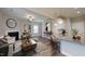 Stylish open-concept living and kitchen area with a cozy fireplace, hardwood floors, and a breakfast bar at 150 Hanover Ct, Clayton, NC 27527