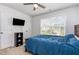 Bedroom with a ceiling fan, carpet and a window that brings in natural light; a TV hangs on the wall at 150 Sherrill Place Ln, Garner, NC 27529