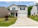 Charming two-story home with landscaped front yard and an attached two-car garage at 150 Sherrill Place Ln, Garner, NC 27529