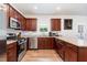 Stylish kitchen featuring stainless steel appliances, granite countertops and wooden cabinets at 150 Sherrill Place Ln, Garner, NC 27529