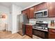 Beautiful kitchen with stainless steel appliances, granite countertops, and rich wood cabinetry at 150 Sherrill Place Ln, Garner, NC 27529