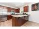 Well-equipped kitchen with stainless steel appliances, granite countertops, and rich wood cabinetry at 150 Sherrill Place Ln, Garner, NC 27529