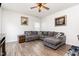 Comfortable living room features wood floors, a sectional couch, and a ceiling fan at 150 Sherrill Place Ln, Garner, NC 27529