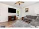 Cozy living room features a decorative fireplace, a large TV, and a comfortable sectional sofa at 150 Sherrill Place Ln, Garner, NC 27529