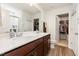 Well-lit main bathroom with double sinks, granite countertops, and walk in closet at 150 Sherrill Place Ln, Garner, NC 27529