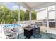 Covered patio with outdoor seating, a fire table, and a view of the backyard pool at 150 Sherrill Place Ln, Garner, NC 27529