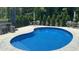 Beautiful in-ground pool features patio furniture and a landscaped fence in a private backyard setting at 150 Sherrill Place Ln, Garner, NC 27529
