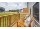 Cozy wooden balcony with chairs and scenic neighborhood views, perfect for relaxing outdoors at 1515 Tamarisk Ln, Durham, NC 27703