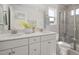 Elegant bathroom boasts double vanity, large mirror, and glass-enclosed shower at 1515 Tamarisk Ln, Durham, NC 27703