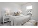 Light-filled bedroom with plush bedding, stylish nightstands, and a view of the neighborhood at 1515 Tamarisk Ln, Durham, NC 27703