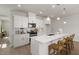 Bright kitchen features white cabinets, stainless steel appliances, and a spacious island with seating at 1515 Tamarisk Ln, Durham, NC 27703
