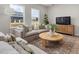 Bright living room with comfortable seating, neutral decor, and large windows at 1515 Tamarisk Ln, Durham, NC 27703