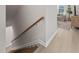 Wooden staircase featuring a handrail and neutral walls, leading to an airy living space at 1515 Tamarisk Ln, Durham, NC 27703
