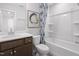 Bright bathroom featuring a bathtub, shower, and modern vanity at 1517 Tamarisk Ln, Durham, NC 27703
