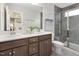 Modern bathroom with double vanity, tiled shower, and neutral color scheme at 1517 Tamarisk Ln, Durham, NC 27703