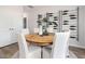 Stylish dining room featuring a round table, neutral colors, and decorative wine rack at 1517 Tamarisk Ln, Durham, NC 27703