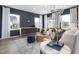 Inviting living room featuring large windows, modern furniture, and open layout at 1517 Tamarisk Ln, Durham, NC 27703