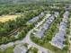 An aerial view of a neighborhood featuring lush greenery, a pond, and a baseball field in the background at 1720 Laurel Park Pl, Cary, NC 27511