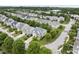 Bird's-eye view of houses with manicured lawns, mature trees, and neatly arranged streets in a suburban setting at 1720 Laurel Park Pl, Cary, NC 27511
