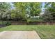 Green backyard with landscaping and retaining wall at 1720 Laurel Park Pl, Cary, NC 27511