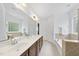 Spacious bathroom with double sinks, large vanity, separate tub, and tile flooring at 1720 Laurel Park Pl, Cary, NC 27511