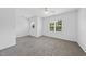 Spacious bedroom with neutral carpet, a ceiling fan, and large windows allowing natural light at 1720 Laurel Park Pl, Cary, NC 27511